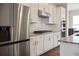 Modern kitchen featuring stainless steel appliances, white cabinets, and granite countertops with tile backsplash at 308 Overture Ct, Smyrna, GA 30080
