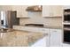 Modern kitchen featuring stainless steel appliances, white cabinets, and granite countertops, providing a chef's haven at 308 Overture Ct, Smyrna, GA 30080