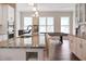 Bright kitchen featuring an island with a granite countertop and a sink, open to a game room with a pool table at 308 Overture Ct, Smyrna, GA 30080