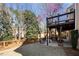 Lush backyard with a tiered deck, privacy fence, and a well-maintained lawn at 3285 Millwood Se Trl, Smyrna, GA 30080