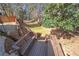 Inviting backyard deck with stairs descending into a scenic, grassy ravine surrounded by mature trees and lush greenery at 3285 Millwood Se Trl, Smyrna, GA 30080