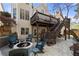 Spacious backyard with a stone patio, fire pit, and a tiered deck with stairs at 3285 Millwood Se Trl, Smyrna, GA 30080
