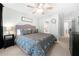 Comfortable bedroom featuring a queen bed, ceiling fan and natural lighting from several windows at 3285 Millwood Se Trl, Smyrna, GA 30080