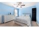 Bright bedroom featuring a queen bed, dresser, bookcase and light blue walls at 3285 Millwood Se Trl, Smyrna, GA 30080
