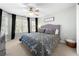 Comfortable bedroom featuring a queen bed, ceiling fan and natural lighting from several windows at 3285 Millwood Se Trl, Smyrna, GA 30080