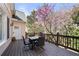Outdoor deck area with dining table and chairs. Features a view of a blooming tree at 3285 Millwood Se Trl, Smyrna, GA 30080
