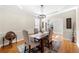Inviting dining room with hardwood floors, tray ceiling, chandelier, and natural light at 3285 Millwood Se Trl, Smyrna, GA 30080