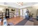 Large exercise room with an elliptical, rowing machine, and built-in storage shelves at 3285 Millwood Se Trl, Smyrna, GA 30080