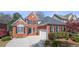 Charming two-story brick home with manicured lawn, black shutters, and attached garage at 3285 Millwood Se Trl, Smyrna, GA 30080