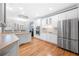 Bright kitchen with stainless steel appliances, breakfast bar, and hardwood floors at 3285 Millwood Se Trl, Smyrna, GA 30080