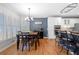 Open kitchen and dining area with stainless steel appliances and hardwood floors at 3285 Millwood Se Trl, Smyrna, GA 30080