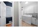 Modern laundry room with front-load washer and dryer, and utility sink at 3285 Millwood Se Trl, Smyrna, GA 30080