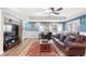 Cozy living room with wood-look floors, a decorative rug, and a sliding glass door to the backyard at 3285 Millwood Se Trl, Smyrna, GA 30080