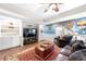 A comfy living room featuring a large TV and built-in bookshelves and a stylish rug at 3285 Millwood Se Trl, Smyrna, GA 30080
