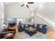 Cozy living room with fireplace, hardwood floors, and open view to the kitchen at 3285 Millwood Se Trl, Smyrna, GA 30080