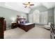 Vaulted ceiling main bedroom featuring a ceiling fan, many windows, and neutral carpet at 3285 Millwood Se Trl, Smyrna, GA 30080