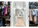 View through walk-in closet into light-filled main bathroom at 3285 Millwood Se Trl, Smyrna, GA 30080