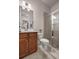 A bathroom features a glass shower stall, wood cabinets, and a modern mirror at 11620 Crestview Ter, Johns Creek, GA 30024