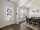 Formal dining area with stylish lighting fixture and hardwood floors, perfect for entertaining at 11620 Crestview Ter, Johns Creek, GA 30024