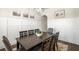 Elegant dining room featuring sophisticated wainscoting, a modern chandelier, and stylish decor at 11620 Crestview Ter, Johns Creek, GA 30024