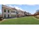 Rear exterior showing a lawn, covered patio, and a row of well-maintained houses at 11620 Crestview Ter, Johns Creek, GA 30024