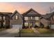 Charming two-story brick home with attached garage and well-manicured lawn at dusk at 11620 Crestview Ter, Johns Creek, GA 30024