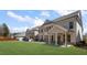Home's exterior showing a patio, spacious yard, and elegant architectural details at 11620 Crestview Ter, Johns Creek, GA 30024