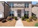 Inviting entryway with a decorative wreath and well-landscaped bushes at 11620 Crestview Ter, Johns Creek, GA 30024