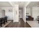 Hallway featuring beautiful trim work and hardwood flooring with views into the living and dining rooms at 11620 Crestview Ter, Johns Creek, GA 30024