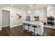 A modern kitchen features white cabinetry, stainless steel appliances, and a center island with marble countertops at 11620 Crestview Ter, Johns Creek, GA 30024