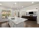 An open-concept kitchen with a marble island provides views of the living room, fireplace, and backyard at 11620 Crestview Ter, Johns Creek, GA 30024