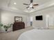 Large main bedroom boasts tray ceilings, neutral colors, ceiling fan and adjacent ensuite access at 11620 Crestview Ter, Johns Creek, GA 30024