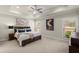 Spacious main bedroom featuring tray ceilings, large windows, and neutral color palette at 11620 Crestview Ter, Johns Creek, GA 30024