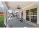 Covered patio area showcasing a ceiling fan, brick accents, and views of the grassy backyard at 11620 Crestview Ter, Johns Creek, GA 30024