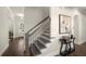 A staircase with wooden steps and black iron railings leads to the second floor of this modern home at 11620 Crestview Ter, Johns Creek, GA 30024