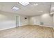 Finished basement with durable laminate flooring, recessed lighting, and ample space for entertainment or storage at 1431 Brandy Shoals Se Ct, Conyers, GA 30013