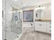Bathroom with marble-look tile, soaking tub, glass shower, and white vanity at 1431 Brandy Shoals Se Ct, Conyers, GA 30013
