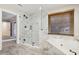 Modern bathroom featuring a glass shower, soaking tub, and window with blinds for natural light at 1431 Brandy Shoals Se Ct, Conyers, GA 30013