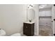 Bathroom featuring a dark wood vanity and an oval mirror, conveniently located near the laundry area at 1431 Brandy Shoals Se Ct, Conyers, GA 30013