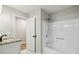 Bathroom with granite countertops, white cabinetry, modern fixtures, and bathtub shower combination at 1431 Brandy Shoals Se Ct, Conyers, GA 30013