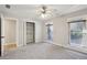 Bedroom featuring neutral walls, two bright windows, and access to closet and bathroom at 1431 Brandy Shoals Se Ct, Conyers, GA 30013