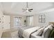Main bedroom featuring a tray ceiling, ceiling fan, and ensuite bathroom at 1431 Brandy Shoals Se Ct, Conyers, GA 30013