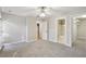 Large bedroom featuring neutral walls, plush carpeting, and access to closet and bathroom at 1431 Brandy Shoals Se Ct, Conyers, GA 30013