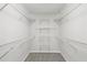 Spacious walk-in closet with ample shelving and carpeted floor for organized storage at 1431 Brandy Shoals Se Ct, Conyers, GA 30013