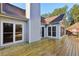 The wooden deck is attached to the home's light grey siding and the screened porch at 1431 Brandy Shoals Se Ct, Conyers, GA 30013