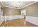 Dining room with chair rail, chandelier, and hardwood floors at 1431 Brandy Shoals Se Ct, Conyers, GA 30013