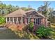 Classic brick home with a charming front porch, complemented by lush landscaping and a welcoming entrance at 1431 Brandy Shoals Se Ct, Conyers, GA 30013