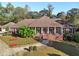 Charming brick home with a landscaped front yard, mature trees, and a welcoming front porch at 1431 Brandy Shoals Se Ct, Conyers, GA 30013