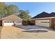 Multiple detached garages offering ample parking space, surrounded by mature trees at 1431 Brandy Shoals Se Ct, Conyers, GA 30013