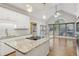 Bright kitchen with granite countertops, stainless steel appliances, and an island cooktop with natural light at 1431 Brandy Shoals Se Ct, Conyers, GA 30013
